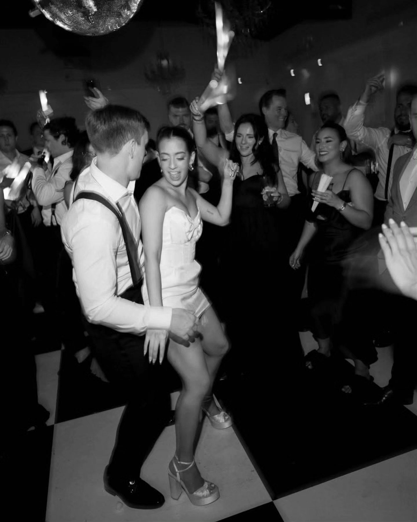 "Lights, laughter, and love in motion! The perfect Miami night under the disco ball. ✨🖤 
.
.
Venue: @theclubofknights
Planner: @amandagrahamevents
Photo: @nadiadiaznaval
Video: @melsfilms
Makeup & Hair: @madeyoulookk @myl.bridal
DJ & Photobooth: @visiondis
Content Creator: @contentconamor
Signage: @miamiwritesco
Rentals: @contempolinens & @simplerustic
Disco Ball: @madoddevents
Coffee Station: @aromaespressocappuccinobar
Musicians: @elegantmusicians
Dance Floor: @wrapmyfloor
.
.
.
.
#EpicCelebrations #MiamiWeddings #DanceTheNightAway"